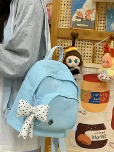 Light blue mini backpack with cute polka-dot bow, perfect sweet style detail and everyday casual use.