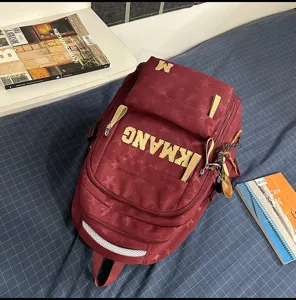 Vintage style star pattern burgundy backpack with large letter design for daily school and travel.