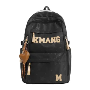 Black canvas student backpack with star pattern, letter print and heart pendant, front view.