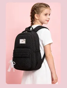 Detailed view of the girls polka dot school backpack featuring cute lace pendant and pocket.