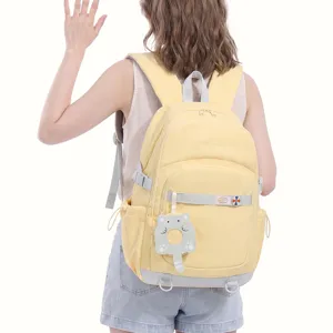 Sac a dos d'etudiant jaune minimaliste de grande capacite avec adorable pendentif de chat mignon