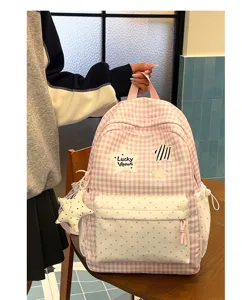 Korean style pink plaid backpack detail, cute heart pattern front pocket and star pendant.