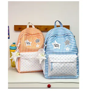 Detailed view of cute Korean style plaid school backpack with heart pattern and star patch.