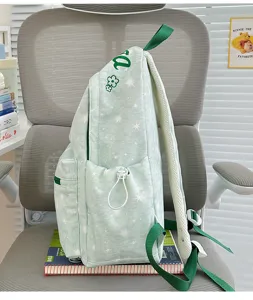 Casual printed backpack side detail showing light green star pattern, pocket, and straps.