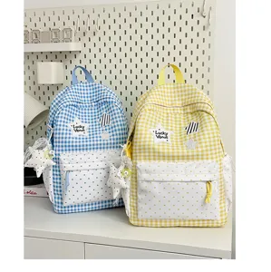 Cute plaid school backpack with polka dot front pocket and star pendant for students.