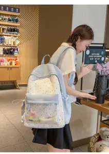 Detail view of the sweet star pattern school backpack with clear front pocket in light blue.