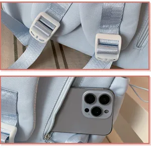 Backpack detail view showing adjustable white plastic buckles and convenient zipper pocket storage.
