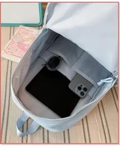 Light blue minimalist casual backpack interior detail showcasing large storage capacity pockets.