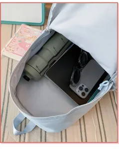 Light blue student backpack interior detail showing large capacity storage and design.