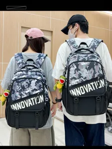 Detail view of the trendy camouflage utility backpack with letter print and cute dinosaur pendant.