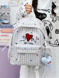 Detailed view of casual plaid backpack featuring embroidered red heart and cute love letters.
