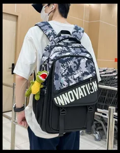 Stylish camouflage tactical backpack with English print and cute plush dinosaur pendant.