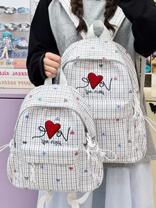 Detail view of Japanese ins casual plaid school backpack with heart embroidery and dual sizes.