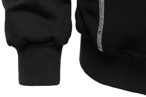 Black hoodie detail shot highlighting contrast white stitching and ribbed cuffs for men and women.