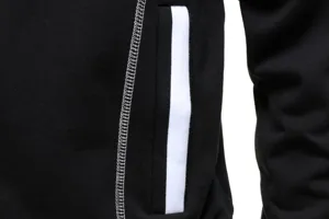 Close-up detail of black hoodie pocket and contrast stitching, casual sportswear style.