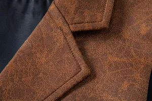 Close-up detail of men's vintage brown suede lapel suit waistcoat showing fine stitching.