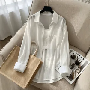 Textured white long-sleeve sunscreen shirt detail with pocket and camisole set on beige chair.