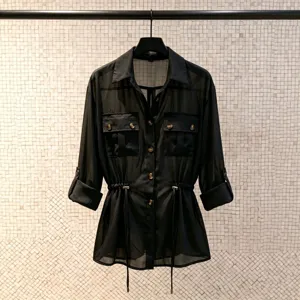Black sheer chiffon utility shirt featuring gold buttons, elegant lapels and a waist drawstring.