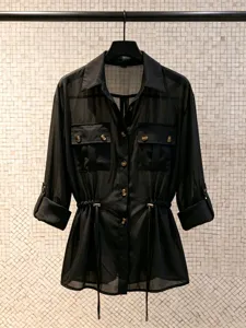 Elegant black sheer chiffon blouse with waist drawstring, utility pockets and chic rolled sleeves.