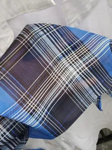 Blue black plaid chiffon fabric detail view, lightweight summer breathable shirt material.