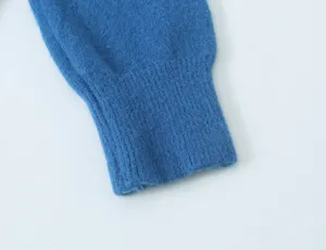 Detailopname van de zachte blauwe gebreide vestmouw manchet met fijne ribbeltextuur.
