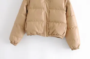 Faux leather puffer jacket with a stand collar, snap button closure, and elastic hem.