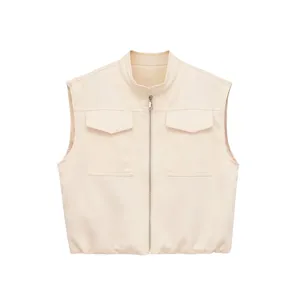 Close-up detail of cream faux leather vest featuring stand collar, full zip and pockets.