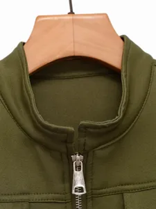 Detailed view of women's olive green stand collar zip up vest, quality fabric, commuter style.