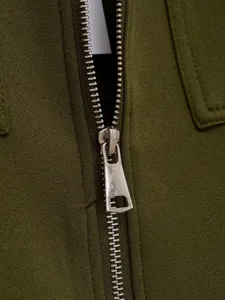 Close-up detail of women casual zip-up vest fabric and metallic zipper design.