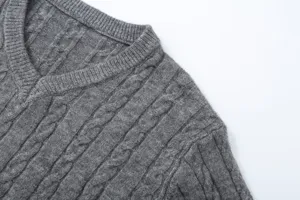 Close up detail of women grey V-neck cable knit sweater, showing soft texture and fine stitching.
