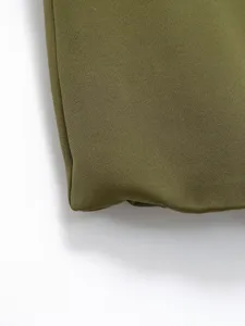 Close-up detail of the olive green fabric texture, showing fine weave and neat stitching.