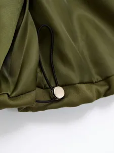 Close-up detail of military green women clothing with black drawstring and silver metal stopper.