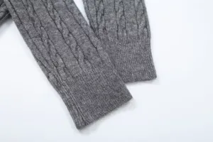 Grey cable knit sweater sleeve detail, cozy long sleeve winter fashion apparel top.