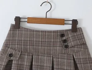 Brown plaid pleated skirt detail view, commuter college style women's fashion bottom garment.