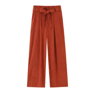 Rust brown corduroy high-waist wide-leg pants featuring a stylish matching bow belt detail.