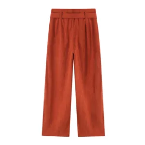 Corduroy wide leg trousers fabric texture and elegant high waist belt design feature.