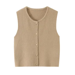 Detailed view of soft knit texture and elegant golden buttons on the stylish knitwear top.