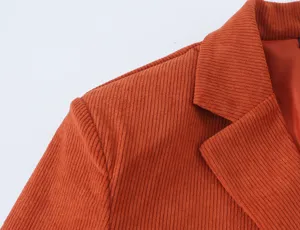 Detailed close-up of a stylish women's corduroy blazer featuring classic lapel collar and shoulder.