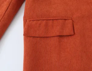 Orange corduroy blazer pocket detail close up shot stylish women daily wear fabric texture