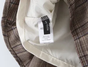 Plaid pleated skirt interior washing label detail view, high quality nylon fabric.