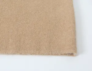 Close up of premium camel knitted cardigan fabric texture, soft wool blend material detail.