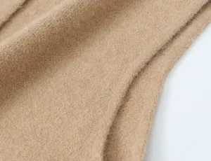 Detailed view of the camel woolen cardigan fabric, soft and cozy texture for women's daily wear.