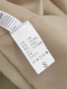 Close-up of the apparel wash care label showing fabric composition and size detail.
