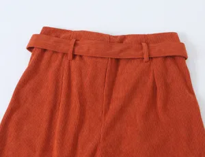 Orange corduroy pants waist detail shot, high waist design with belt loops, stylish commute.