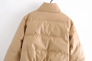 Stylish women faux leather puffer jacket detail view, minimalist solid color winter warm coat.