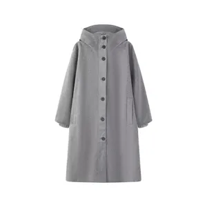 Detailed view of the stylish women's hooded long parka coat, featuring button closure and cozy fabric.
