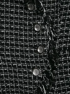 Black and white tweed fabric detail shot with metal buttons for women's blazer.