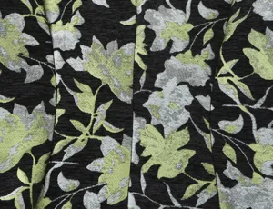Close-up detail of women blazer fabric with elegant black and green floral jacquard weave.