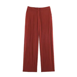 Brick red wide-leg trousers detail shot, showing high waist design, pockets and comfortable fabric.
