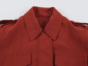Red safari style women jacket collar detail, casual outerwear featuring lapel and pockets.